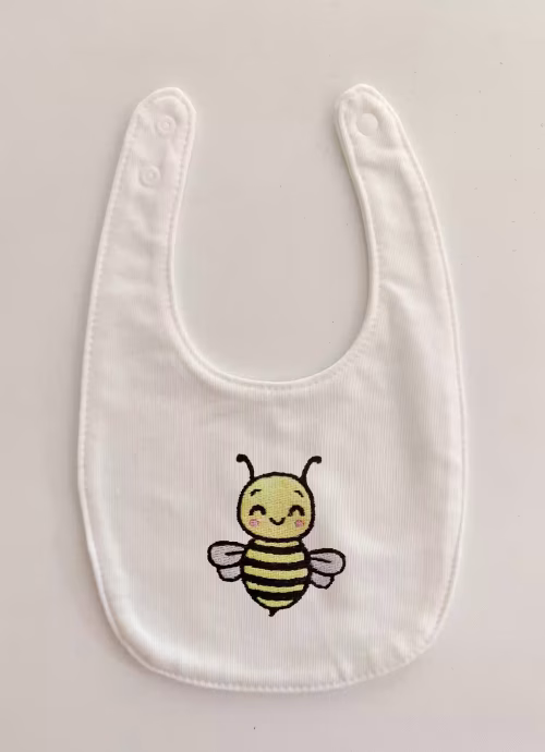 Fotografia di un bavaglino per neonato con un'ape ricamato sulla parte centrale.